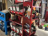 a red shelving with lots of tools on it in a garage