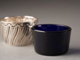 two cups sitting next to each other on a table