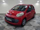 voiture rouge de marque Citrole garée dans un showroom au sol en damier