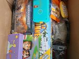 a cardboard box filled with games and other items