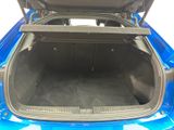 a blue car with its trunk open on the street