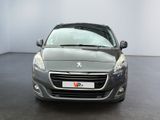 the front view of a grey car parked in a room
