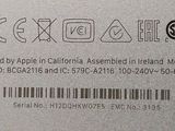 the back of a silver cell phone with a barcode on it