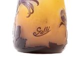 a yellow vase with a palm tree design on it