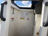 a toilet in the back of a truck with a sign on it