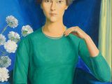 portrait of a woman in a green dress sitting in a blue chair