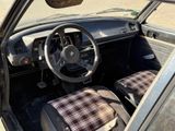 a car with a plaid seat cover and a steering wheel