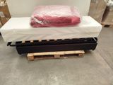 a mattress on a pallet in a warehouse