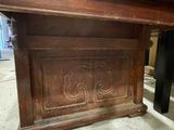 a wooden table with a carved design on it
