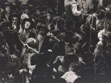 black and white photograph of a crowd of people in hats and tails