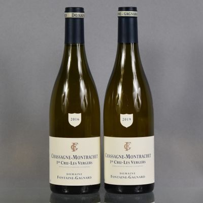 two bottles of white wine sitting on top of a glass table