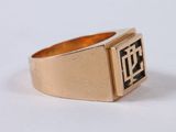 a close up of a gold ring with a black and white design on it