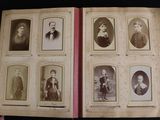 an old photo of a book with a bunch of old photos on it