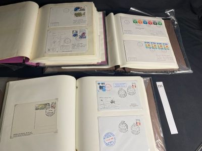 three open books with stamps on them sitting on a table