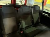 two seats in the back of a bus that are empty