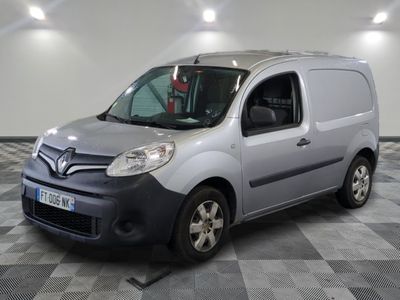 the grey van is parked on a checkered floor in the garage
