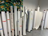 many rolls of paper sitting on the floor next to each other