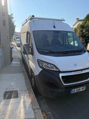 the white van is parked on the side of the street