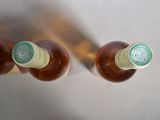 two bottles of beer sitting next to each other on a table