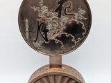 an image of a bronze plate with a man and a woman on it