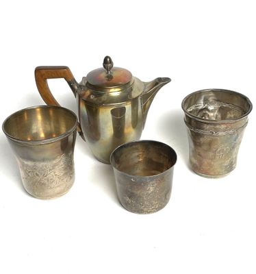 four cups and a teapot sitting on a table