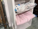 une étagère supérieure en verre sur laquelle sont posés deux sacs de vêtements