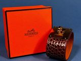 an orange box with a watch inside of it on a blue surface