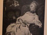 an old black and white photo of a woman laying on a couch