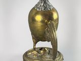 an image of a golden vase with a bird on it