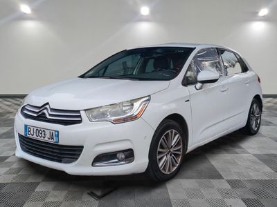 a white citrole is parked in a room with a checkered floor