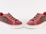 pink sued sneakers with winged wings on the side