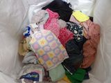 a white bag full of clothes and clothes that are in it