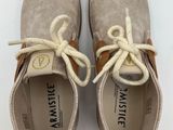 a pair of beige shoes with white laces on them