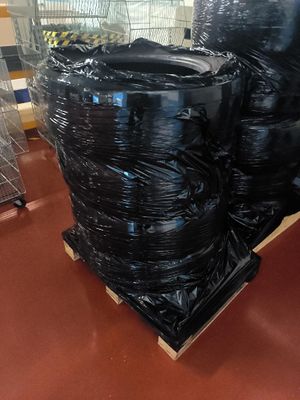 a pile of tires on a pallet in a warehouse
