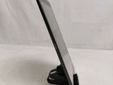 a close up of a tablet computer on a stand on a white surface