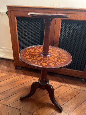 a small table with a wooden top on a wooden floor