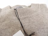 an image of a sweater with a tag on it