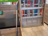 a wooden cabinet with a mop on top of it in a store