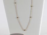 ensemble collier et boucles d'oreilles présenté sur un mannequin blanc