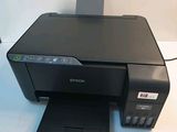 an image of a black printer sitting on top of a white table