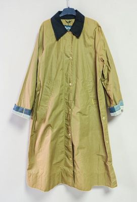 an old coat hanging on a hanger on a wall
