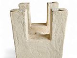 a small cement sculpture of a castle on a white background