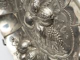a silver plate that has a dragon on it