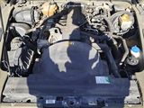 a car with its hood open and the engine in the back of it