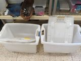 two bins that are sitting next to each other on the floor