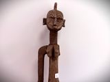 sculpture of a man with a head and arms made of wood