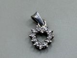 an image of a small diamond pendant on a table