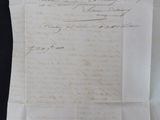an old piece of paper with writing on it sitting on a table
