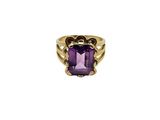 a gold ring with an amethorate stone in the center