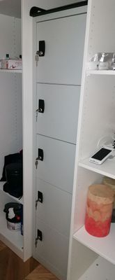 a white closet with a door and shelves in it